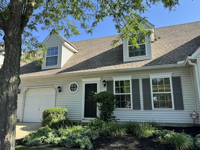 6282 Mcnaughten Place Ln Unit 39, Columbus, OH 43213 - cape cod house featuring a garage and a shingled roof