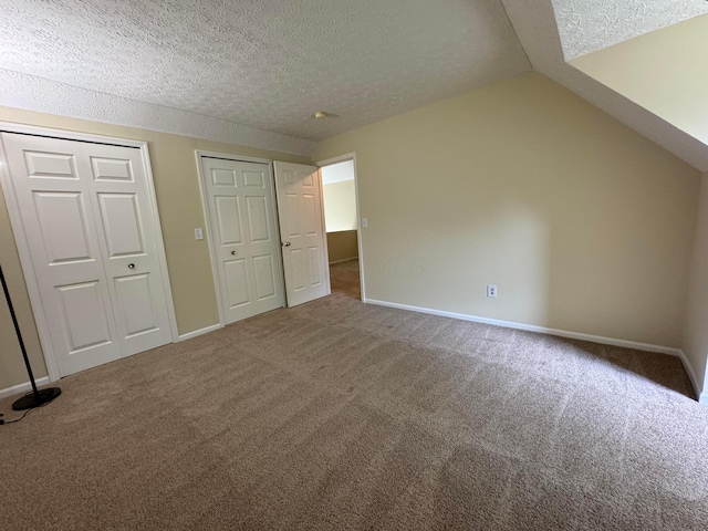 6282 Mcnaughten Place Ln Unit 39, Columbus, OH 43213 - unfurnished bedroom with carpet floors, a textured ceiling, and vaulted ceiling