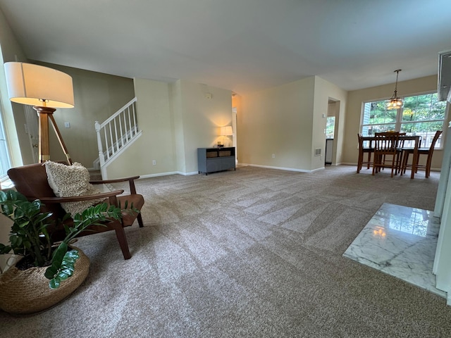 6282 Mcnaughten Place Ln Unit 39, Columbus, OH 43213 - carpeted living room featuring baseboards and stairway