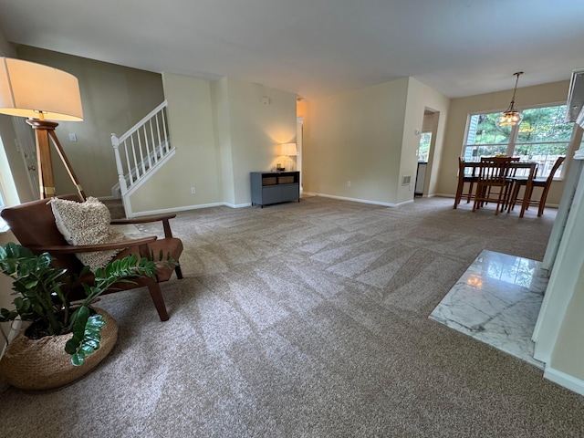 6282 Mcnaughten Place Ln Unit 39, Columbus, OH 43213 - carpeted living room featuring baseboards and stairs