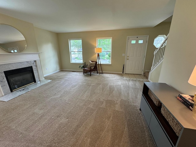 6282 Mcnaughten Place Ln Unit 39, Columbus, OH 43213 - entryway with light colored carpet, a premium fireplace, and stairway