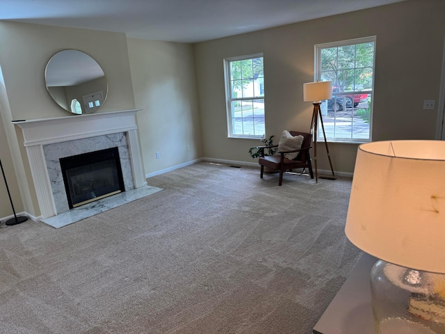 6282 Mcnaughten Place Ln Unit 39, Columbus, OH 43213 - carpeted living room featuring baseboards and a fireplace