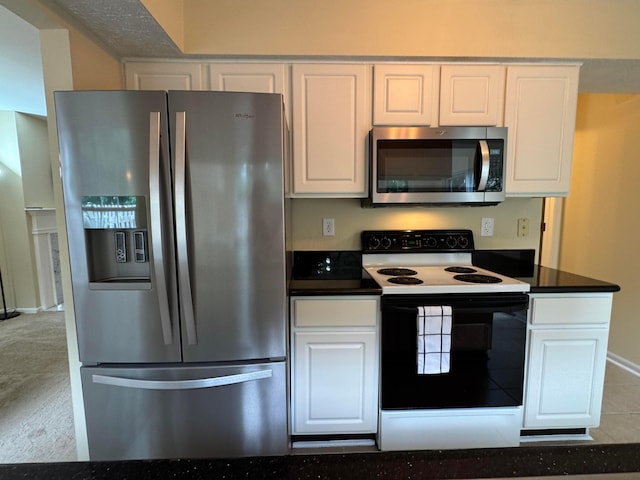 6282 Mcnaughten Place Ln Unit 39, Columbus, OH 43213 - kitchen with stainless steel appliances, white cabinets, and dark countertops