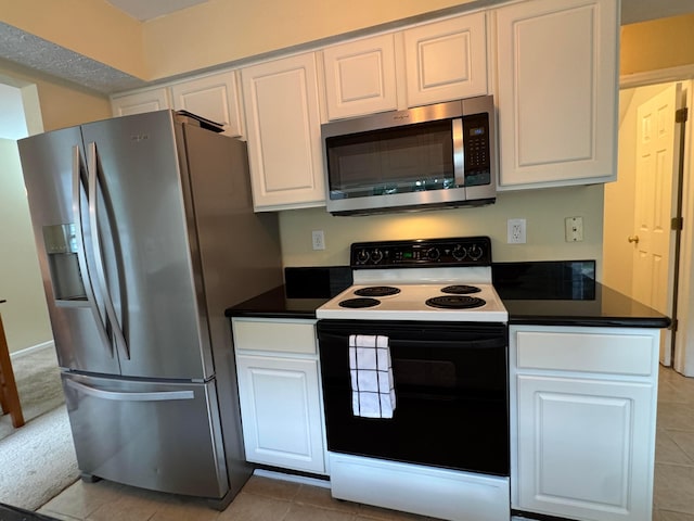 6282 Mcnaughten Place Ln Unit 39, Columbus, OH 43213 - kitchen featuring stainless steel appliances, white cabinetry, and dark countertops