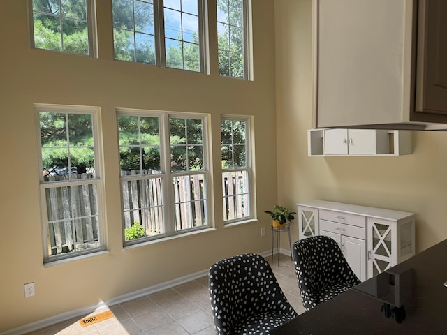 6282 Mcnaughten Place Ln Unit 39, Columbus, OH 43213 - entryway featuring light tile patterned floors, plenty of natural light, and a towering ceiling