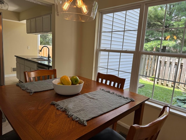 6282 Mcnaughten Place Ln Unit 39, Columbus, OH 43213 - dining area featuring plenty of natural light, a chandelier, and light tile patterned floors