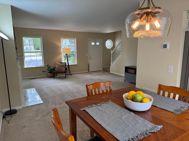 6282 Mcnaughten Place Ln Unit 39, Columbus, OH 43213 - dining room featuring a chandelier, stairway, and carpet floors
