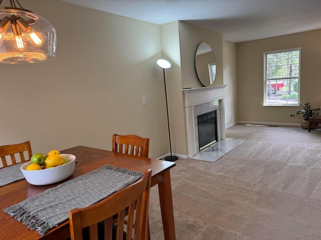 6282 Mcnaughten Place Ln Unit 39, Columbus, OH 43213 - carpeted dining area featuring a high end fireplace and baseboards