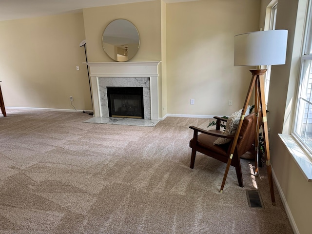 6282 Mcnaughten Place Ln Unit 39, Columbus, OH 43213 - carpeted living area featuring a fireplace and baseboards