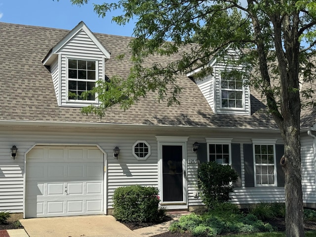 6282 Mcnaughten Place Ln Unit 39, Columbus, OH 43213 - cape cod house featuring a shingled roof, a garage, and concrete driveway