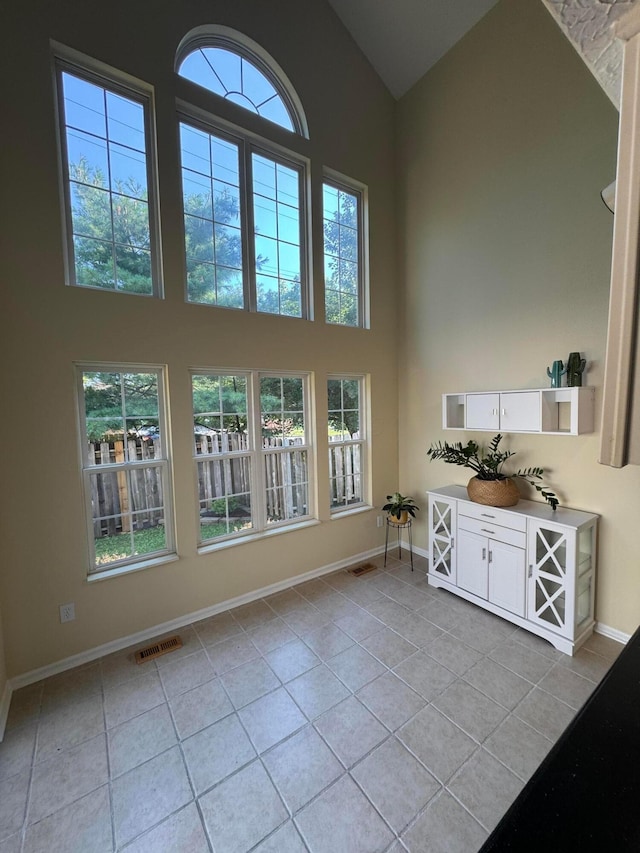 6282 Mcnaughten Place Ln Unit 39, Columbus, OH 43213 - interior space with light tile patterned floors, high vaulted ceiling, and plenty of natural light