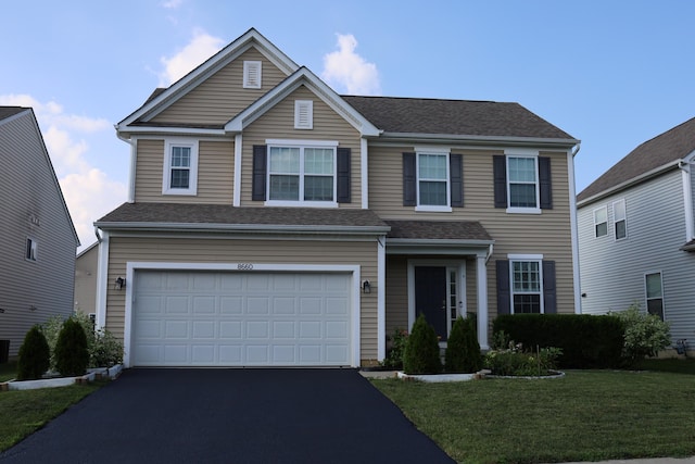 8660 Crooked Maple Dr, Blacklick, OH 43004 - traditional home featuring driveway, an attached garage, a front lawn, and roof with shingles
