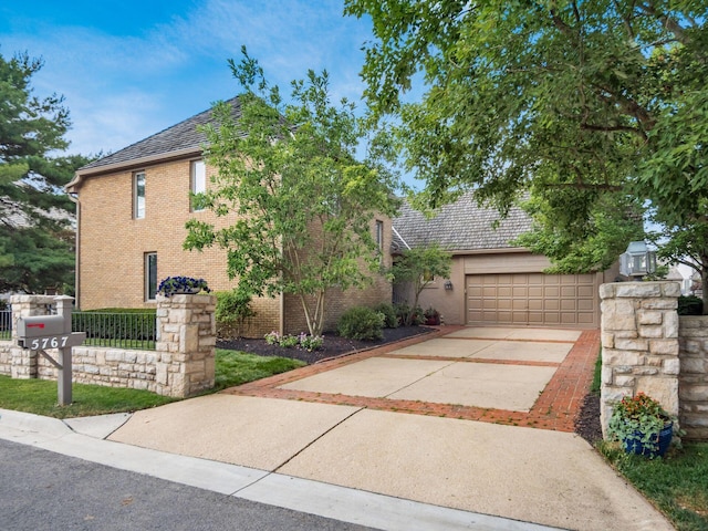 5767 Loch Maree Ct, Dublin, OH 43017 - view of front of home with driveway, brick siding, and an attached garage