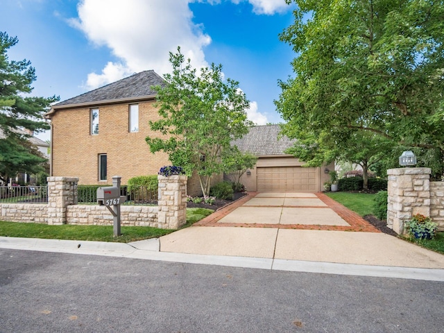 5767 Loch Maree Ct, Dublin, OH 43017 - view of front facade with driveway, brick siding, and an attached garage