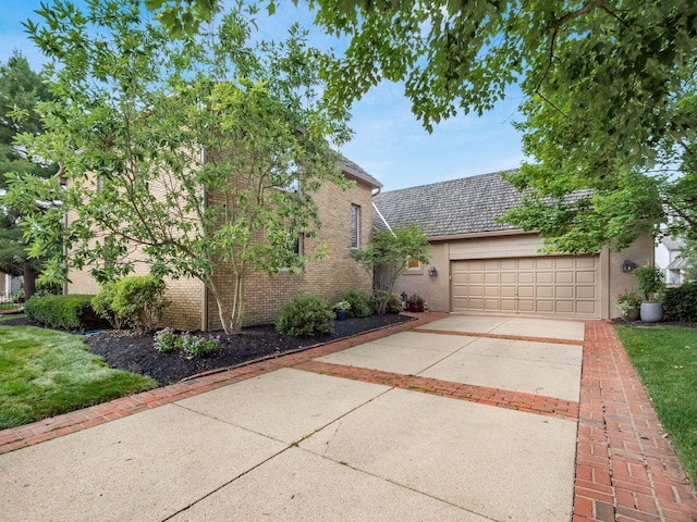5767 Loch Maree Ct, Dublin, OH 43017 - view of front facade with concrete driveway, a garage, and brick siding