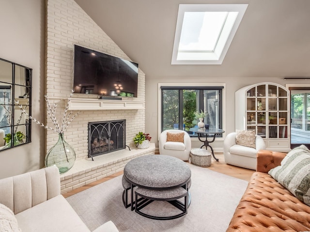 5767 Loch Maree Ct, Dublin, OH 43017 - living room featuring a skylight, lofted ceiling, a fireplace, and wood finished floors