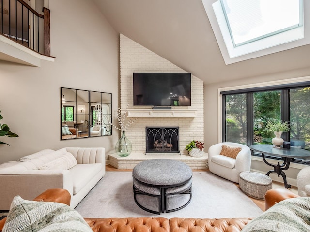 5767 Loch Maree Ct, Dublin, OH 43017 - living room featuring a skylight, a brick fireplace, wood finished floors, and high vaulted ceiling