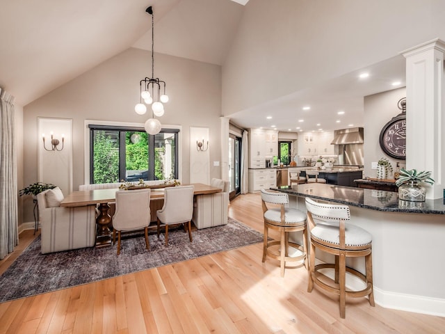 5767 Loch Maree Ct, Dublin, OH 43017 - dining area featuring light wood-type flooring, high vaulted ceiling, and a chandelier