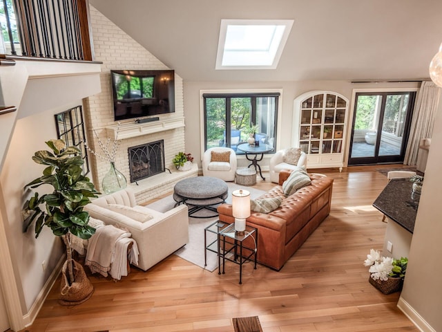 5767 Loch Maree Ct, Dublin, OH 43017 - living area with a skylight, a fireplace, light wood-type flooring, lofted ceiling, and plenty of natural light