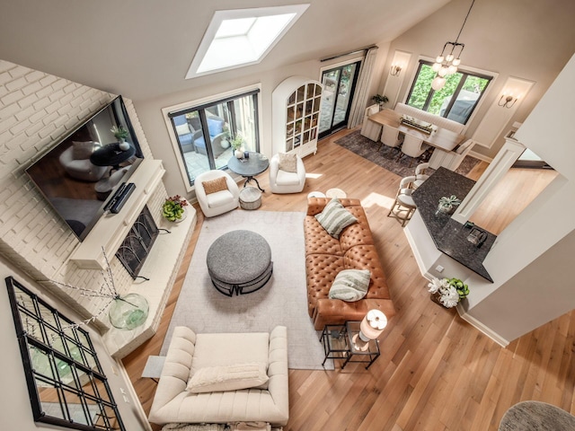 5767 Loch Maree Ct, Dublin, OH 43017 - living area with wood finished floors, a chandelier, and vaulted ceiling