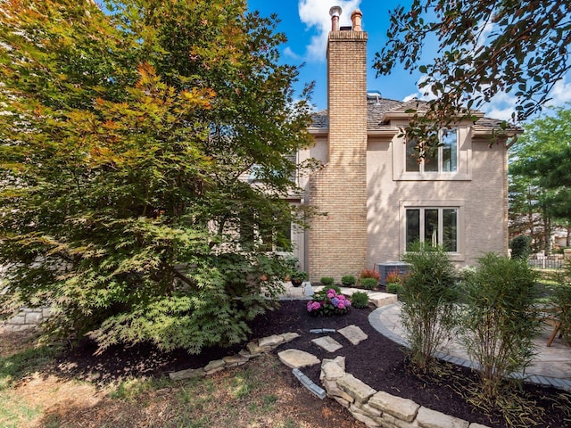5767 Loch Maree Ct, Dublin, OH 43017 - view of property exterior with stucco siding and a chimney