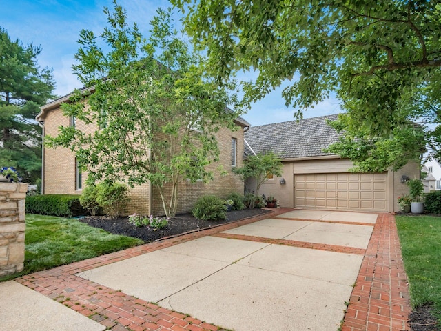 5767 Loch Maree Ct, Dublin, OH 43017 - view of front of house featuring a garage, brick siding, concrete driveway, and a front lawn