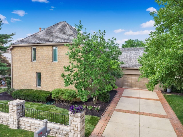 5767 Loch Maree Ct, Dublin, OH 43017 - view of side of home featuring brick siding and concrete driveway