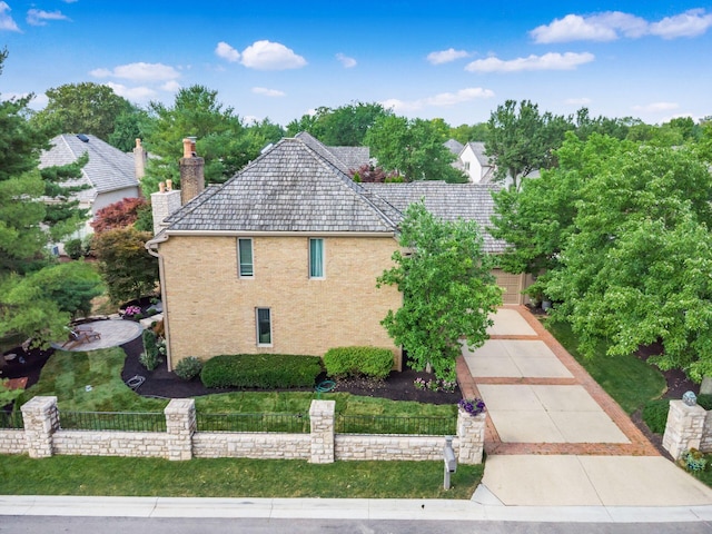 5767 Loch Maree Ct, Dublin, OH 43017 - view of property exterior featuring a chimney, driveway, and brick siding