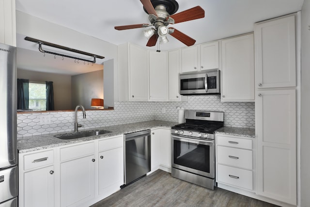 7617 Whitneyway Dr Unit 120, Columbus, OH 43085 - kitchen with stainless steel appliances, white cabinets, wood finished floors, tasteful backsplash, and ceiling fan