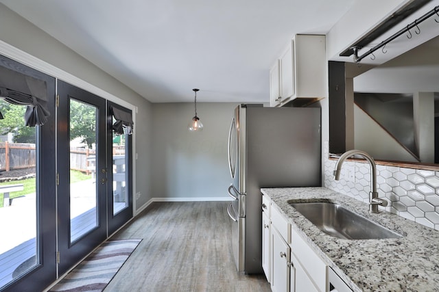 7617 Whitneyway Dr Unit 120, Columbus, OH 43085 - kitchen featuring backsplash, white cabinetry, light stone counters, and french doors