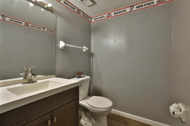 7617 Whitneyway Dr Unit 120, Columbus, OH 43085 - half bathroom featuring wood finished floors, vanity, and a textured ceiling