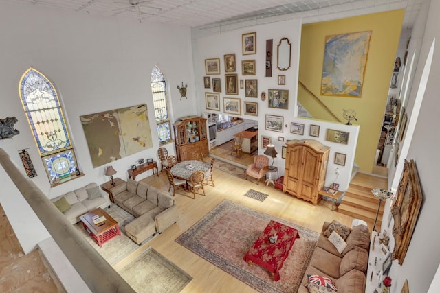 131 E Chestnut St, Lancaster, OH 43130 - living room featuring wood finished floors, a high ceiling, and stairs