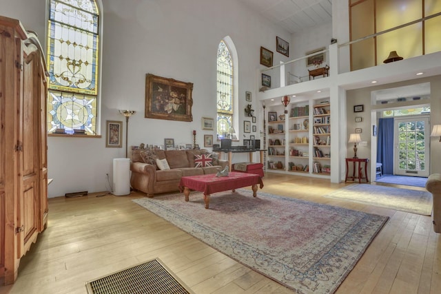 131 E Chestnut St, Lancaster, OH 43130 - living room featuring a high ceiling, plenty of natural light, light wood-type flooring, and built in shelves