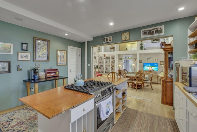 131 E Chestnut St, Lancaster, OH 43130 - kitchen featuring stainless steel gas range oven, recessed lighting, light wood finished floors, open shelves, and a center island