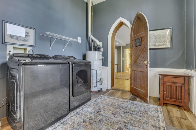 131 E Chestnut St, Lancaster, OH 43130 - washroom with washer and dryer, a wainscoted wall, wood finished floors, gas water heater, and arched walkways