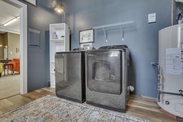 131 E Chestnut St, Lancaster, OH 43130 - washroom featuring washer and clothes dryer, water heater, and wood finished floors