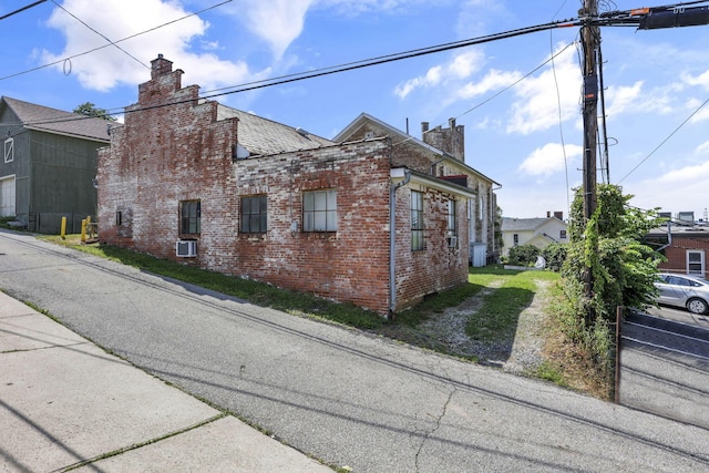 131 E Chestnut St, Lancaster, OH 43130 - view of property exterior featuring a chimney and brick siding