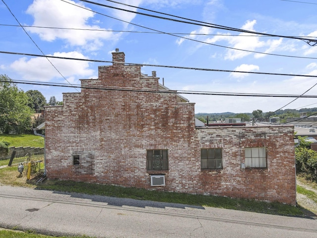 131 E Chestnut St, Lancaster, OH 43130 - view of side of home with brick siding and a chimney