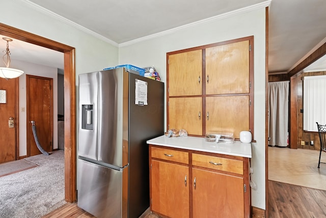 305 N Boston St, Galion, OH 44833 - kitchen featuring stainless steel fridge with ice dispenser, wood finished floors, light countertops, crown molding, and brown cabinets