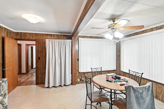 305 N Boston St, Galion, OH 44833 - dining space featuring a ceiling fan, wooden walls, and crown molding