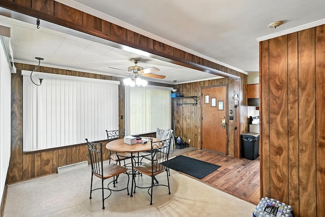 305 N Boston St, Galion, OH 44833 - dining area featuring wood finished floors, wooden walls, a ceiling fan, and ornamental molding