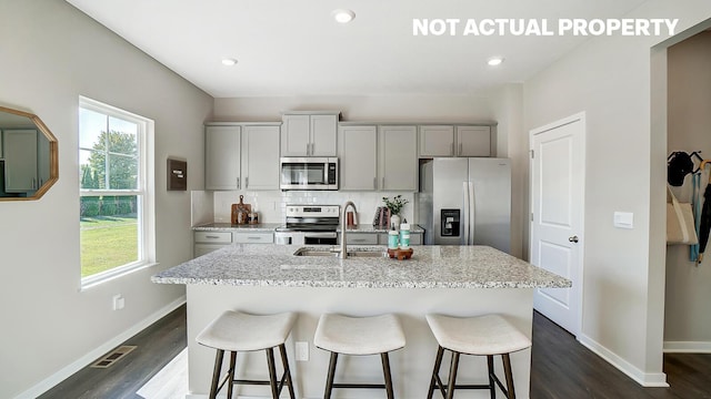 1769 Jacko Ln, Circleville, OH 43113 - kitchen with stainless steel appliances, gray cabinets, a kitchen island with sink, a breakfast bar area, and recessed lighting
