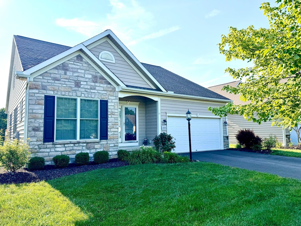 2989 Tree Bend Cir, Grove City, OH 43123 - ranch-style house with stone siding, a garage, a front yard, driveway, and a shingled roof