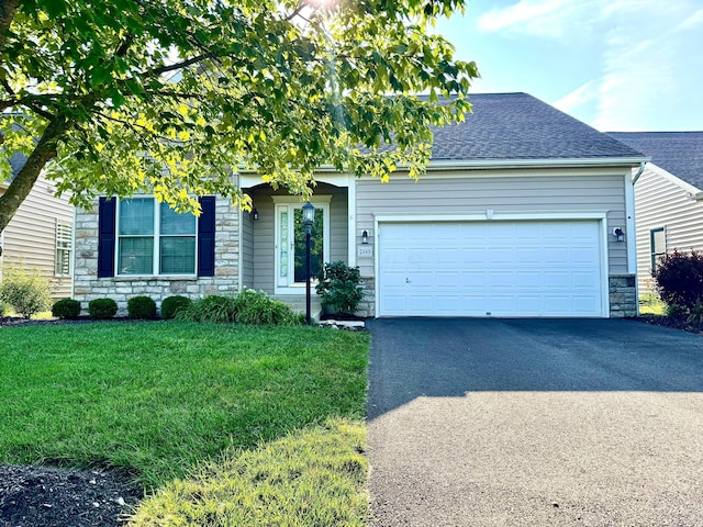 2989 Tree Bend Cir, Grove City, OH 43123 - view of property hidden behind natural elements featuring stone siding, asphalt driveway, a shingled roof, a garage, and a front lawn