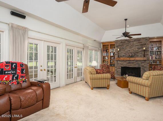 9 Longwood Ct, Okatie, SC 29909 - carpeted living area featuring a fireplace, lofted ceiling, french doors, and ceiling fan