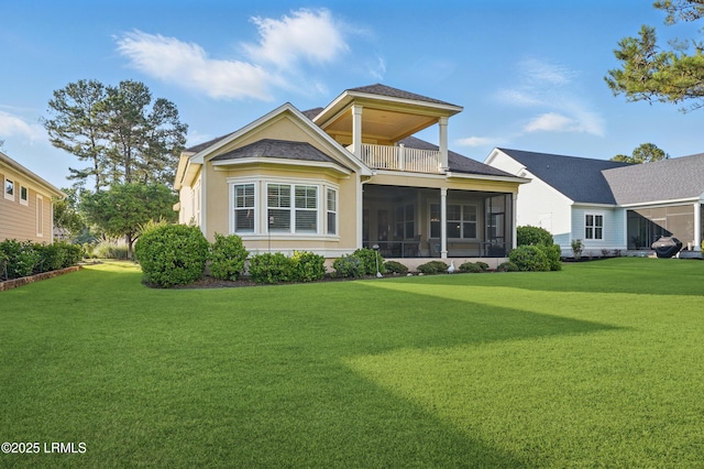 27 Normandy Ave, Bluffton, SC 29910 - rear view of property with a lawn, a sunroom, and a balcony