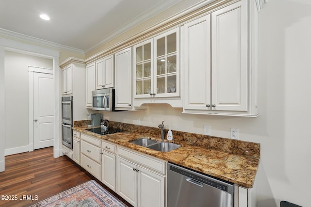 27 Normandy Ave, Bluffton, SC 29910 - kitchen featuring stainless steel appliances, a sink, ornamental molding, dark wood-type flooring, and glass insert cabinets