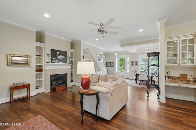 27 Normandy Ave, Bluffton, SC 29910 - living room with dark wood-style floors, a tiled fireplace, a ceiling fan, recessed lighting, and crown molding