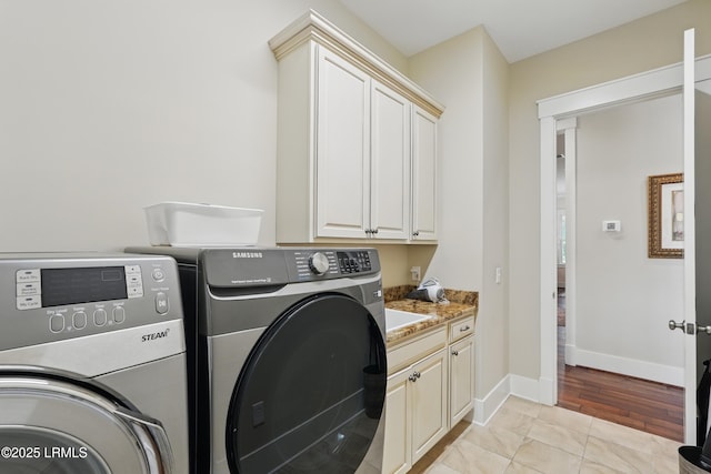 27 Normandy Ave, Bluffton, SC 29910 - laundry room with washer and clothes dryer, cabinet space, and baseboards