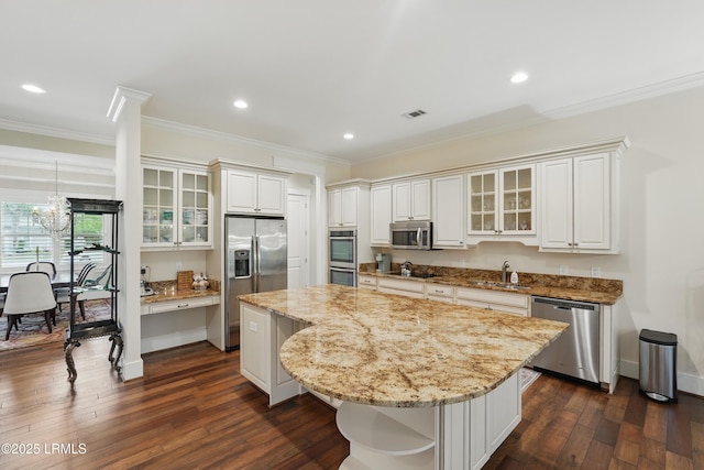 27 Normandy Ave, Bluffton, SC 29910 - kitchen featuring appliances with stainless steel finishes, ornamental molding, a kitchen island, dark wood finished floors, and a chandelier